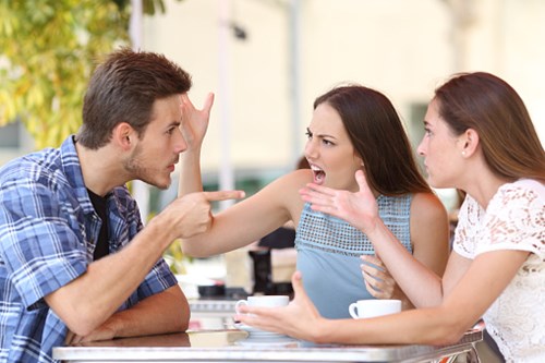 Friends arguing at a coffee shop