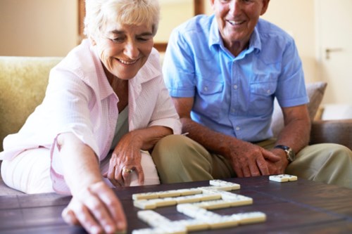Elderly couple playing Scrabble