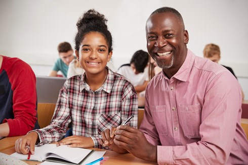 student and teacher smiling