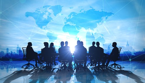 people at meeting desk against global map