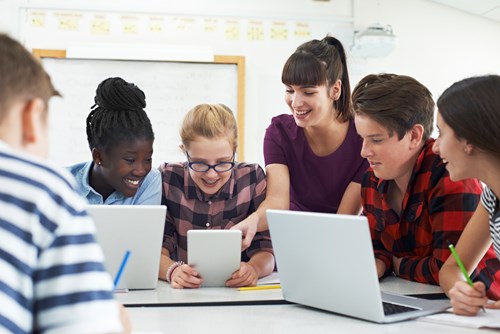 teacher and students with laptops