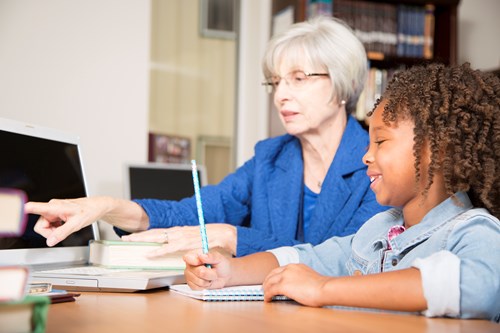 older lady teaching young child