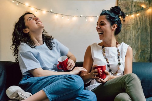 friends laughing on sofa