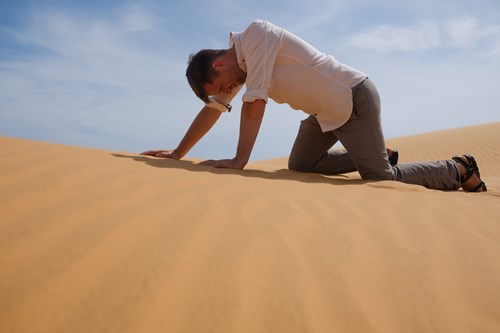 man struggling in desert