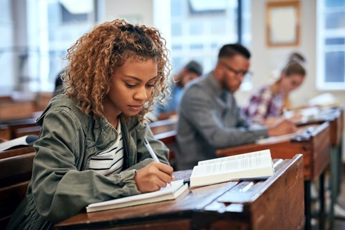 student at desk in classroom