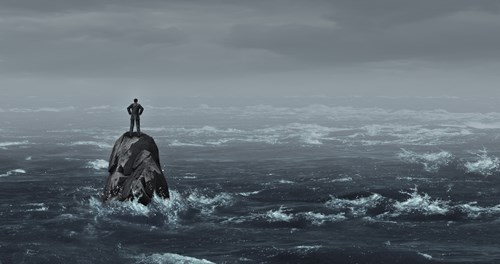 person marooned on rock