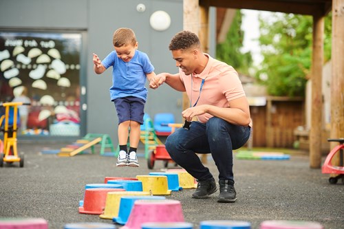 child and teacher in playground