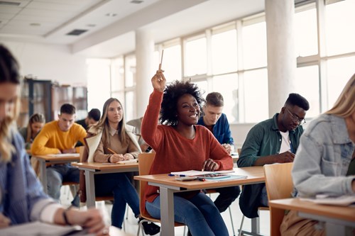 student with hand up